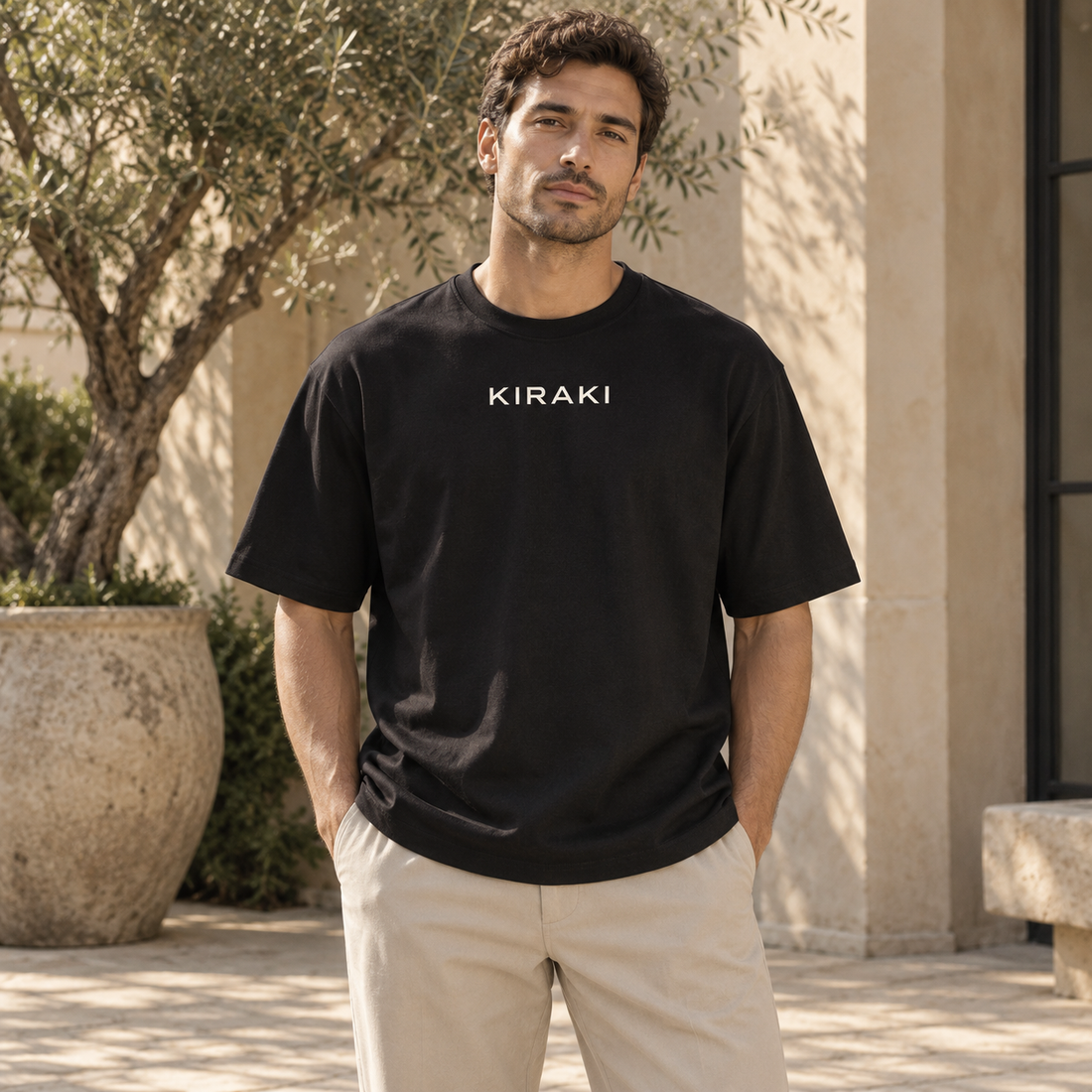 Kiraki Essential 01 black relaxed T-shirt, front studio view with ivory KIRAKI chest print