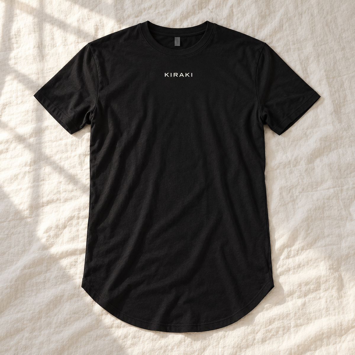 Kiraki Sleep 01 black long-body T-shirt laid on ivory linen